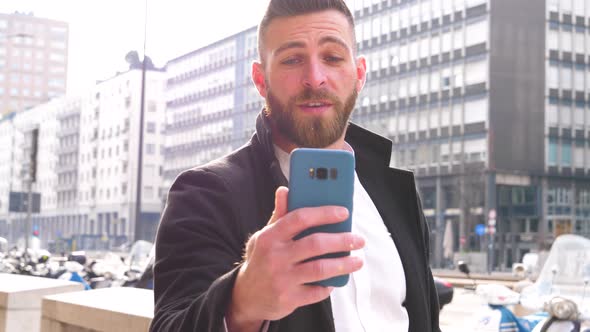 Young man caucasian outdoor using smartphone having video chat