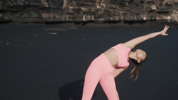 Front View of Young Woman Doing Morning Exercises at the Seashore