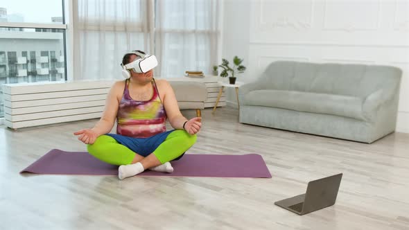Large Fitness Man with Virtual Glasses Doing Yoga Exercises