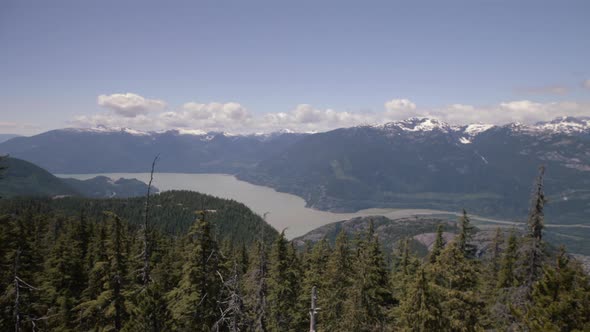 Wide panorama shot of Howe sound on Spring sunny day, more forest in foreground