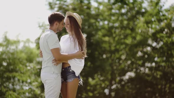 Couple. Man Kissing Beautiful Woman In Nature. Romantic Young People.