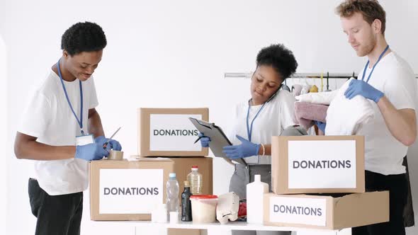 Diverse Charity Volunteers Sorting Through Donated Goods