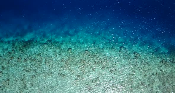 Wide birds eye abstract view of a white sandy paradise beach and blue sea background 