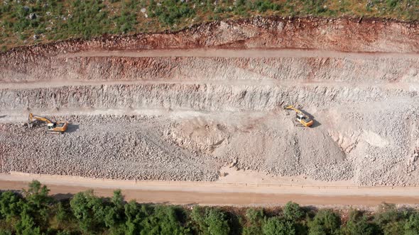 Sidehill cut on the road construction route or quarry. Removing rock and soil from the high side