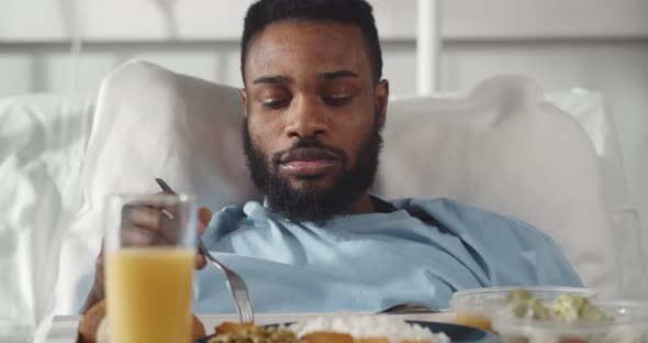 Portrait of Afroamerican Man Eating Healthy Meal in Hospital Room