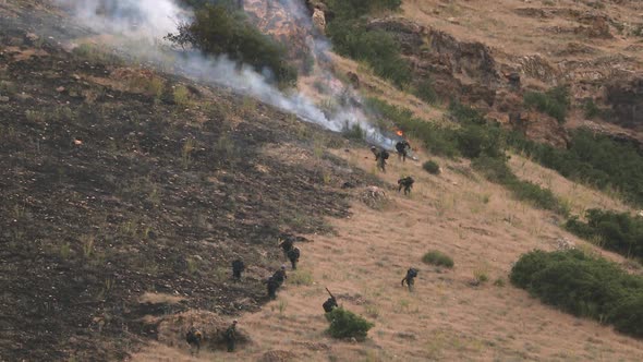 Zoomed view of firefighters working to extinguish wildfire