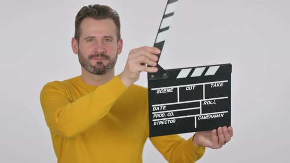Portrait of Middle Aged Man Using Clapperboard