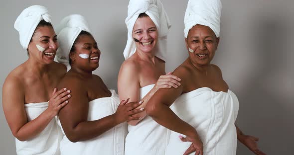 Multi generational women having fun wearing facial beauty mask - Skin care therapy and female power