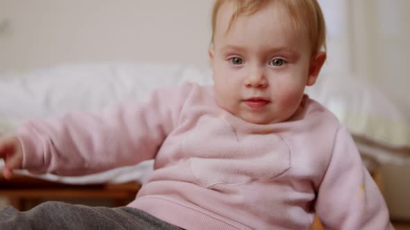 Cute baby playing at home and smiling to the camera