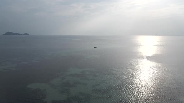 Drone Flying Over Shallow Seascape With Open Water Fish Farm In The Midst