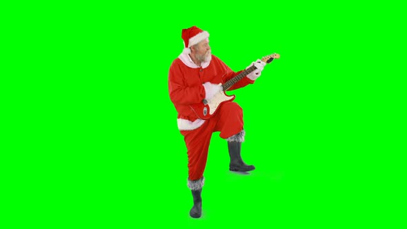 Santa claus singing a song and playing guitar