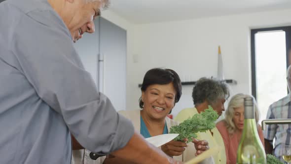 Happy senior diverse people cooking in kitchen at retirement home