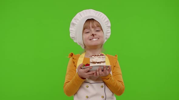 Child Girl Kid Dressed As Professional Cook Chef Showing Eating Tasty Handmade Strawberry Cake