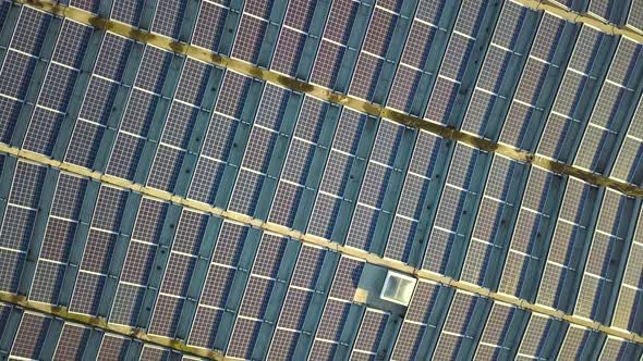 Aerial view of many photo voltaic solar panels mounted of industrial building roof