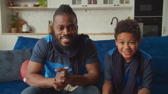 Black Family Watching American Football on Tv Celebrating Successful Reception