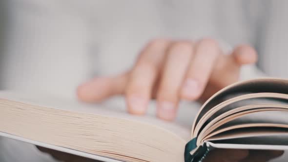 Reading a Book and Turning the Pages Close Up Slow Motion