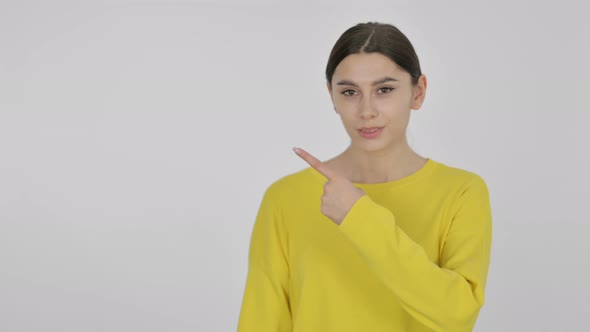 Spanish Woman Pointing Towards Product on White Background