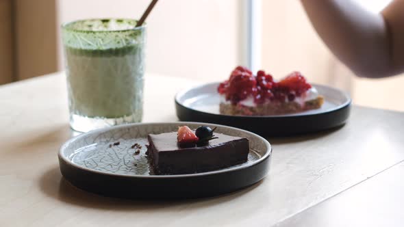 Closeup of Two Women Eating Dessert at Cafeteria