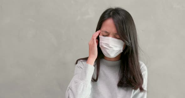 Woman coughing and wearing face mask