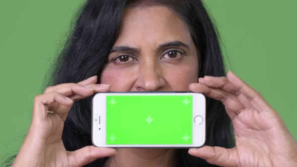 Close Up Shot of Mature Beautiful Indian Woman Showing Phone