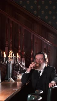 Senior Stylish Man Drinking Alcohol in Pub
