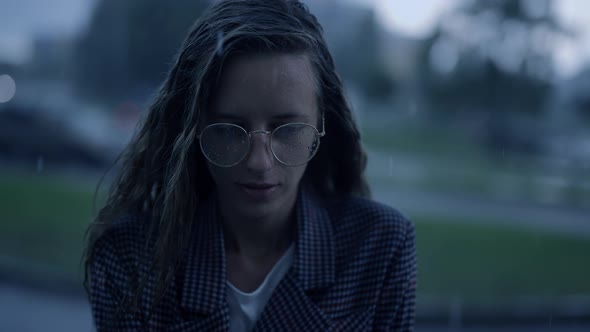 Young Businesswoman is Looking to the Camera in the City While It is Raining