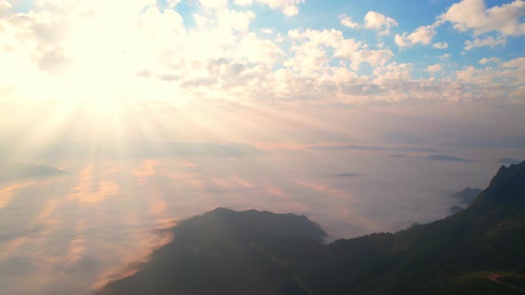 Aerial view from drone, Epic sunbeam over clouds mountains. 4K aerial shot on sunrise