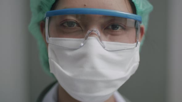 Close Up nurse with face mask in medical protective uniform working in the hospital.