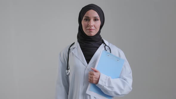 Young Arabian Muslim Woman Islamic Doctor Surgeon in Hijab Wear Medical White Coat Stethoscope