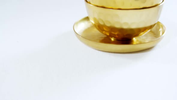 Golden steel bowls and plate on white background 4k