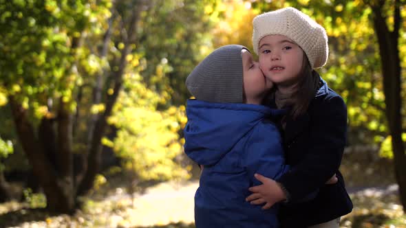 Portrait of Loving Toddler Siblings in Autumn Park