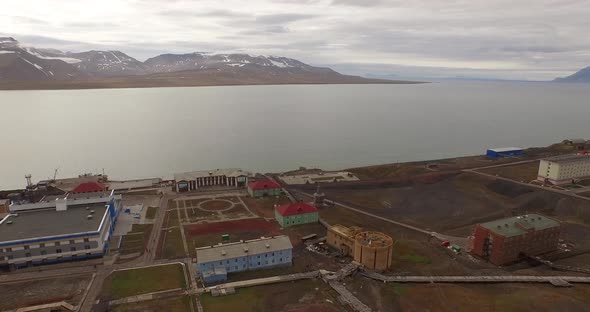 Drone Flight Over the Pipe Stretching By the Ground Along the Settlement of Barentsburg. Spitsbergen