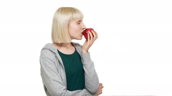 Portrait in Profile of Happy Woman 20s Wearing Casual Clothes Eating Red Juicy Apple Tasting