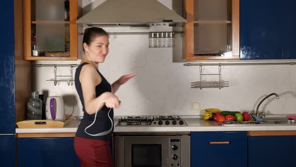 Lady Listens To Music with Headset and Sings Dancing at Home