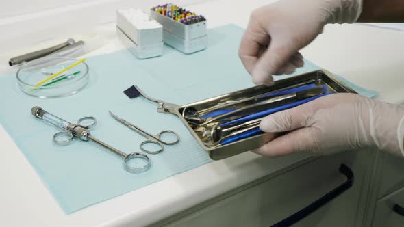 Putting dental instruments on a tray