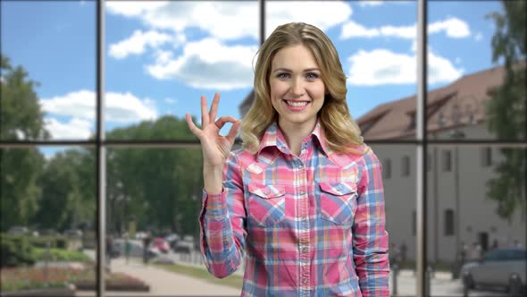 Portrait of Beautiful Girl Showing Ok Gesture