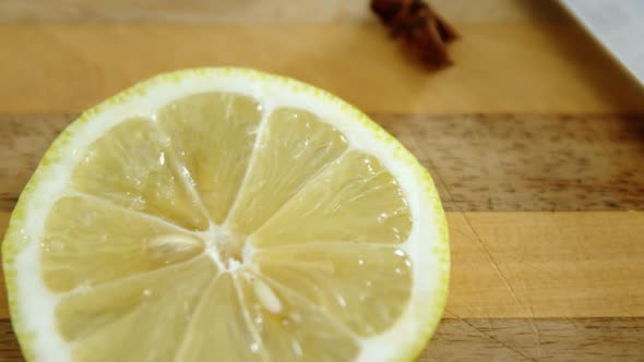 Various spices with lemon slice and knife on chopping board 4k