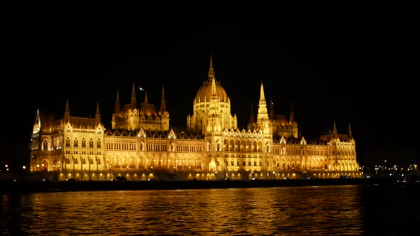 Girl photographing Budapest night parliament