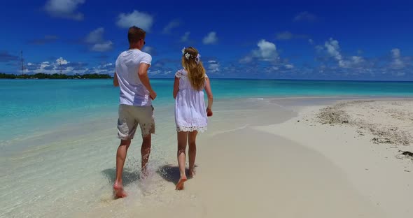 Fun lady and man on romantic honeymoon live the dream on beach on white sand background 4K