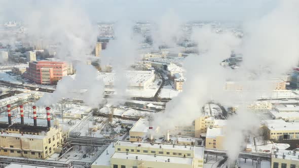 In the winter city, the factory's chimneys are smoking. The concept of air pollution 