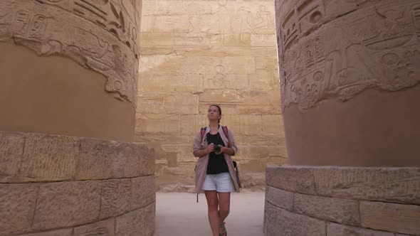 Woman Tourist Walks Between Columns in Ancient Egyptian Karnak Temple