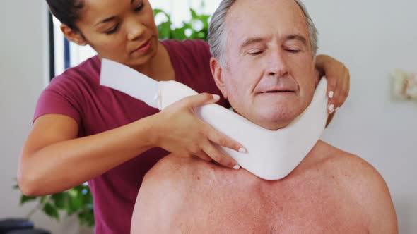 Physiotherapist adjusting cervical collar on the patients neck 4k