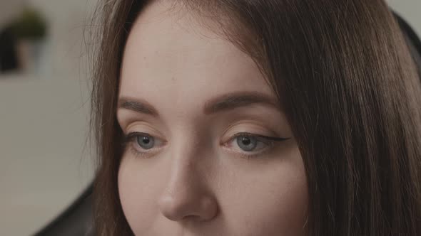 Eyes of a Girl Closeup in a Modern Office Working on a Laptop