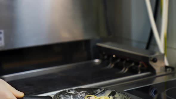 Chef cooking food with pan. Chef preparing food in the restaurant kitchen