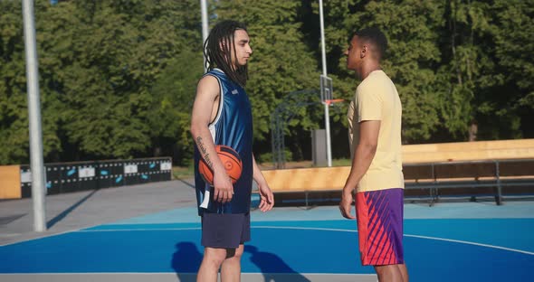 Basketball Players Stand and Look at Each Other Closeup