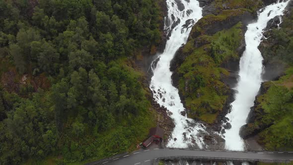 Latefossen Waterfall cascading down Norwegian highland mountain, aerial view