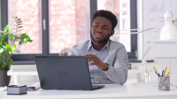 Stressed Businessman with Laptop at Office 