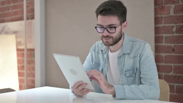 Professional Young Male Designer Using Tablet in Office