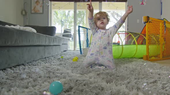 Beautiful Baby Girl Playing with Bubbles at Home