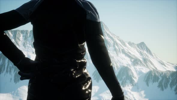 Woman Standing In Snow Wearing Warm Clothes In Mountains alt